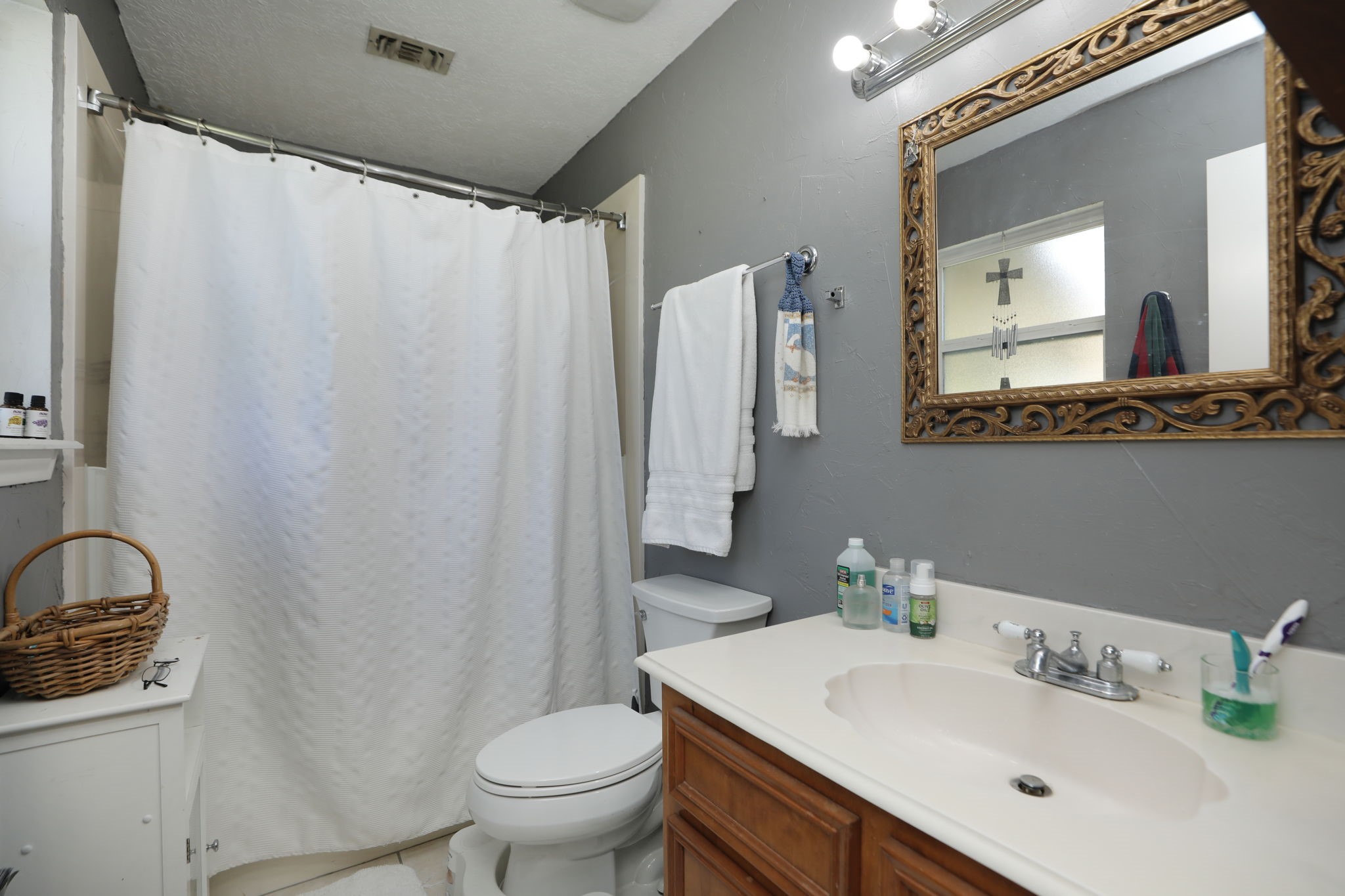 9810 Sugar Tree Court Houston, TX 77070 - Photo 16 of 30 a bathroom with a sink toilet and mirror