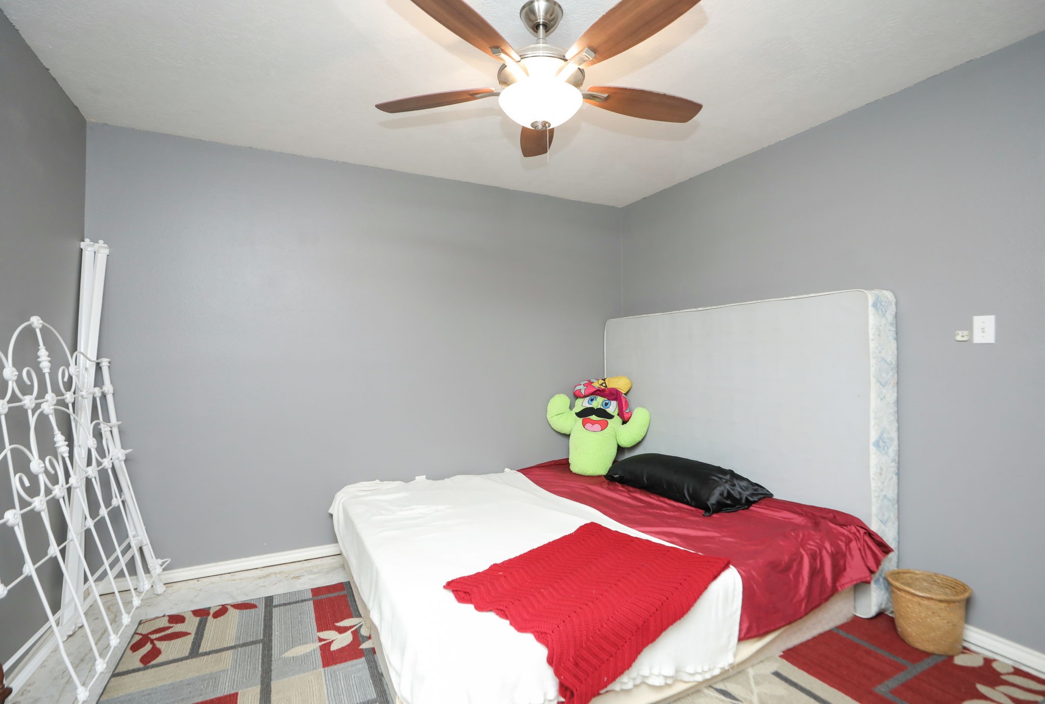 9810 Sugar Tree Court Houston, TX 77070 - Photo 18 of 30 a bedroom with a bed and a chandelier