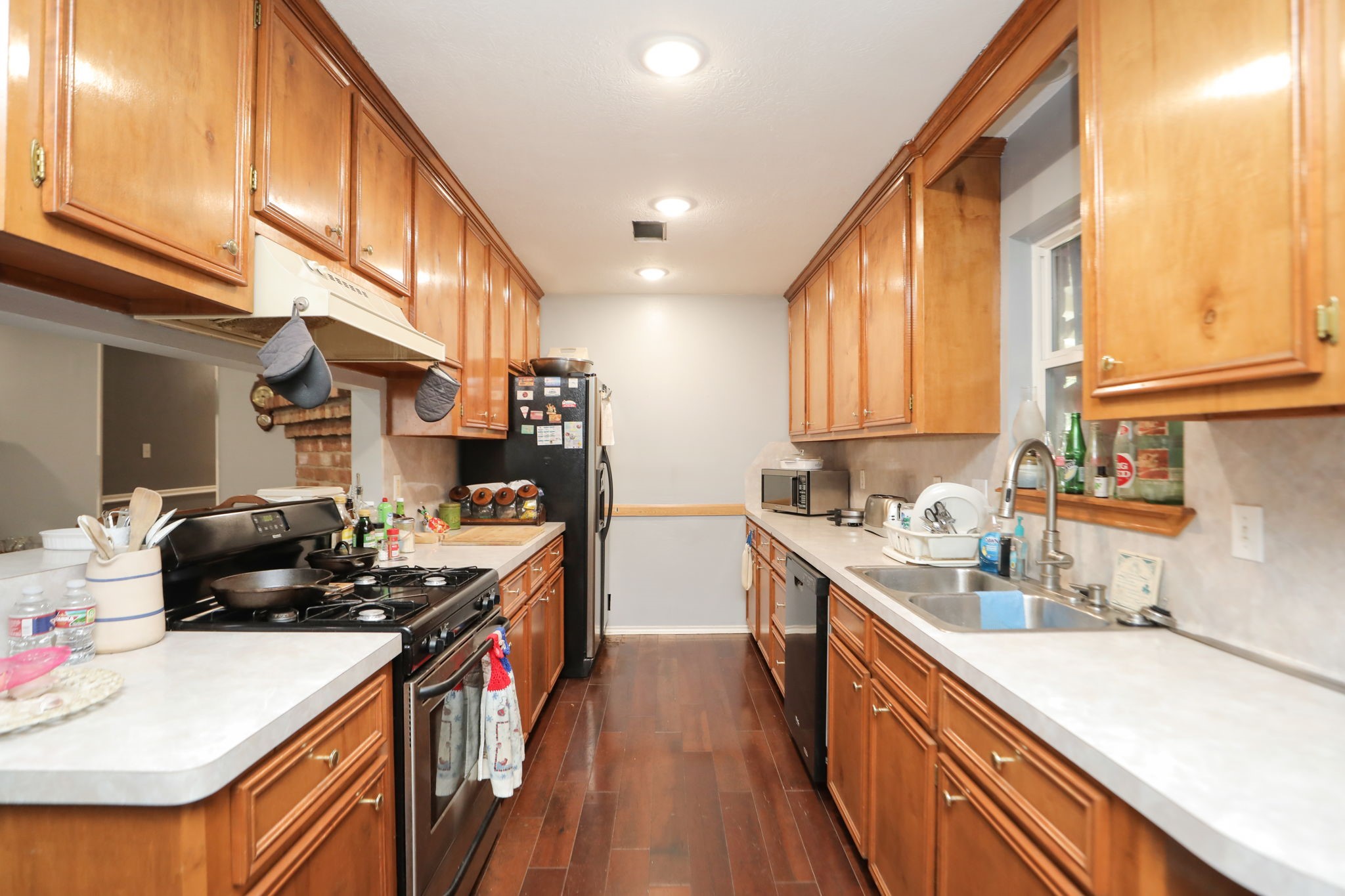 9810 Sugar Tree Court Houston, TX 77070 - Photo 9 of 30 a kitchen with stainless steel appliances a sink a stove and a refrigerator