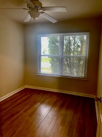 a bathroom with a granite countertop toilet sink and mirror