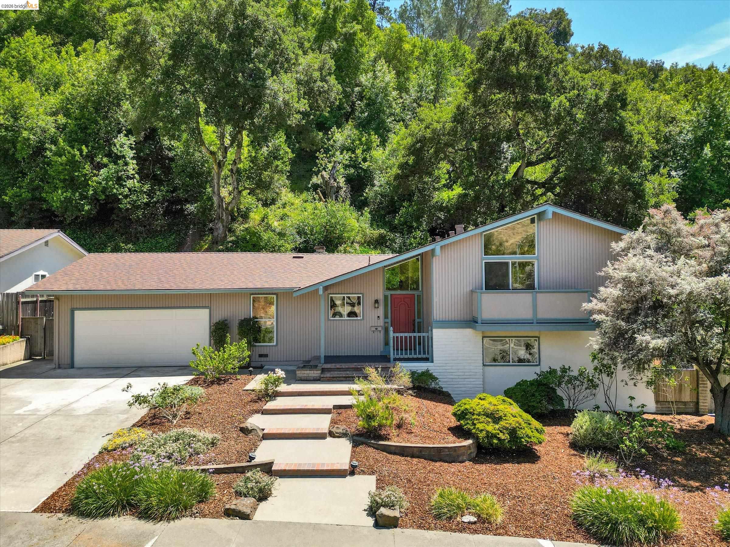 2826 Wright Avenue Pinole, CA 94564 - Photo 1 of 70 Split-level residence featuring a neutral-toned exterior with brick accents and a prominent red entry door