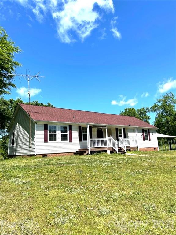 369 Cedar Grove Road Clover, SC 29710 - Photo 1 of 32 a front view of a house with a yard table and chairs
