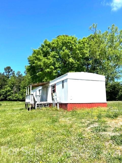 369 Cedar Grove Road Clover, SC 29710 - Photo 16 of 32 a view of a house with a yard potted plants and large tree