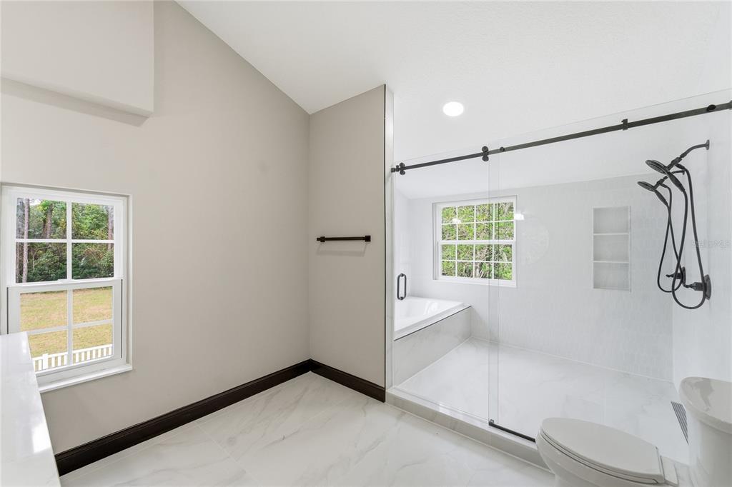 14728 Henson Road Orlando, FL 32832 - Photo 45 of 79 a bathroom with a bathtub and a shower