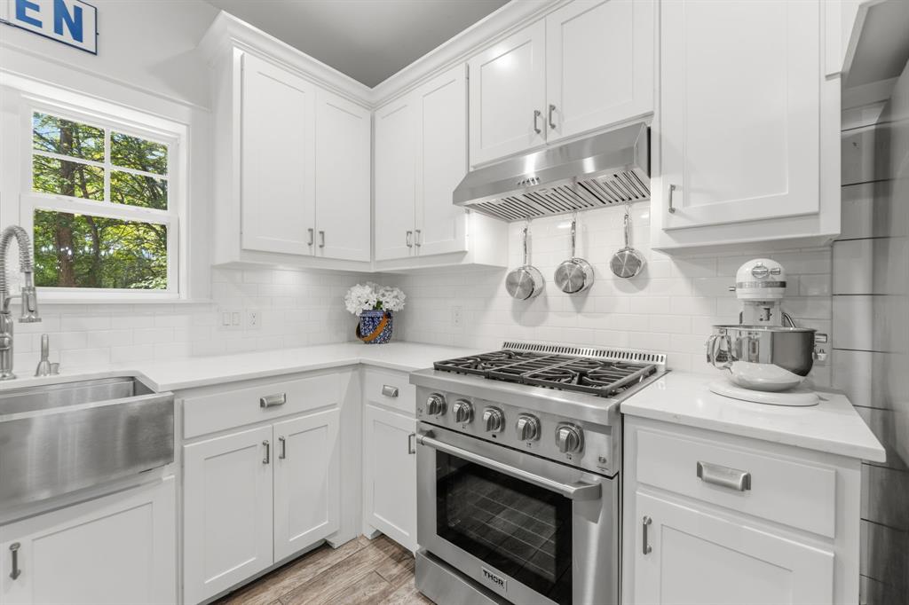 665 Chinn Chapel Road Copper Canyon, TX 75077 - Photo 13 of 26 a kitchen with cabinets appliances and a sink