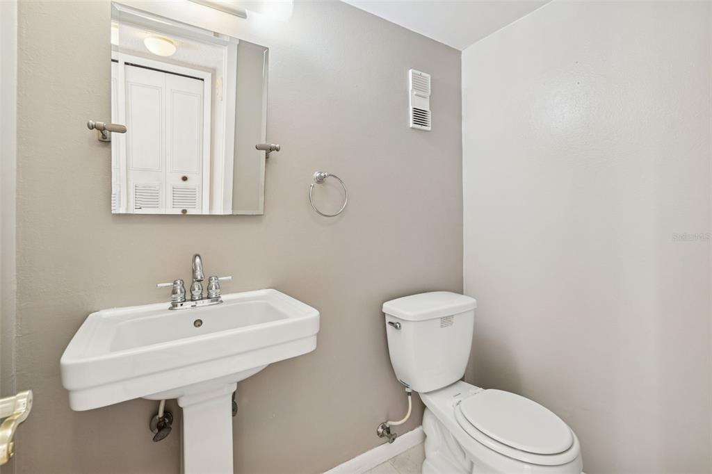 Undisclosed Address Temple Terrace, FL 33617 - Photo 14 of 23 a bathroom with a toilet a sink and mirror