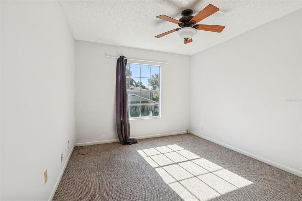 Undisclosed Address Temple Terrace, FL 33617 - Photo 16 of 23 an empty room with windows and fan