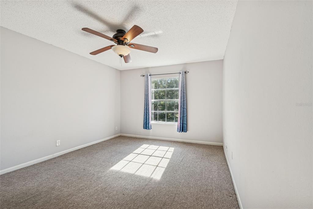 Undisclosed Address Temple Terrace, FL 33617 - Photo 18 of 23 an empty room with windows and fan