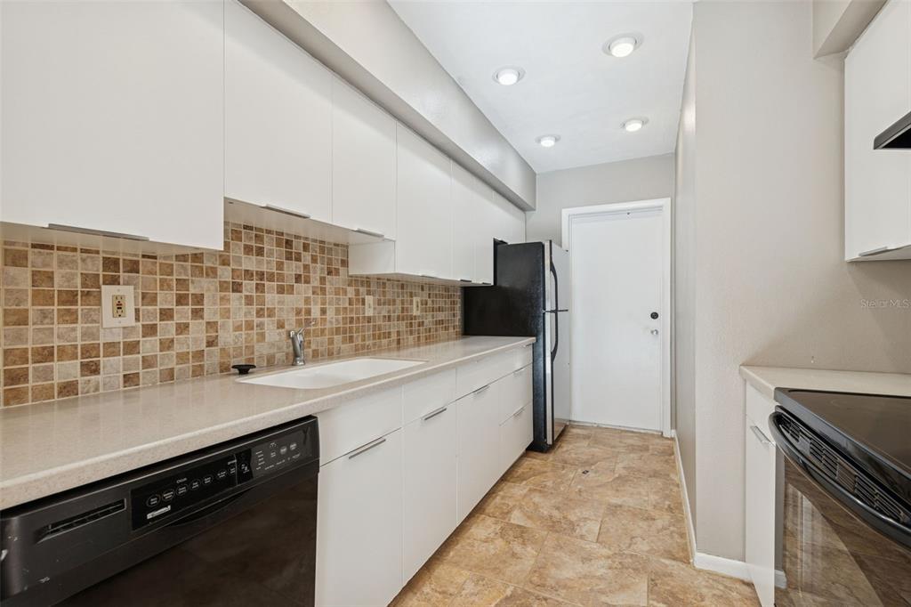 Undisclosed Address Temple Terrace, FL 33617 - Photo 10 of 23 a kitchen with a sink stove and refrigerator