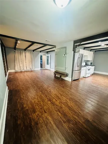 a view of a livingroom with wooden floor and a sink
