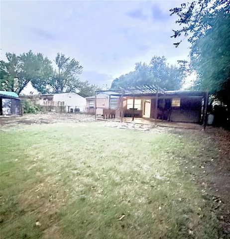 a view of a house with a yard and sitting area