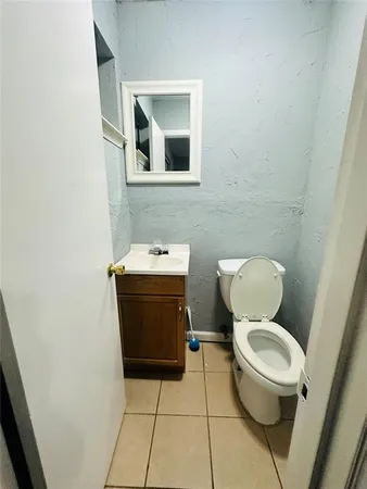 a white toilet sitting next to a bathroom sink