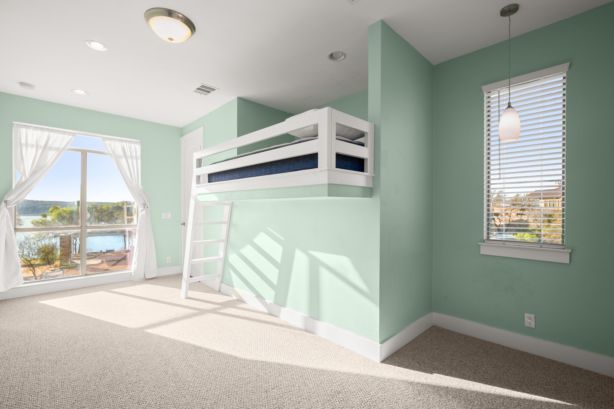 20005 Rod And Gun Club Road Spicewood, TX 78669 - Photo 12 of 39 Unfurnished bedroom featuring light colored carpet and access to exterior