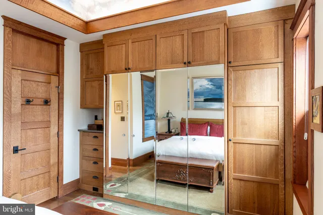 a bedroom with furniture and wooden floor