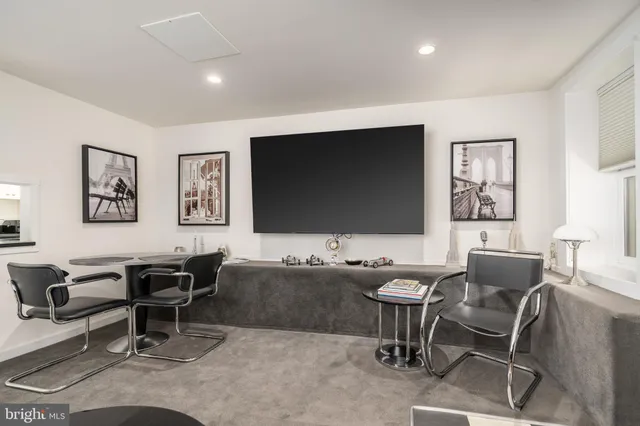 a bedroom with a bed and a chair with potted plant