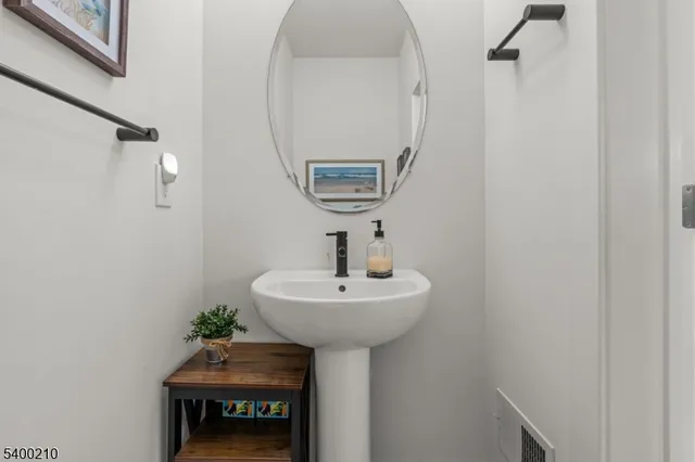 a room with a sink and a mirror