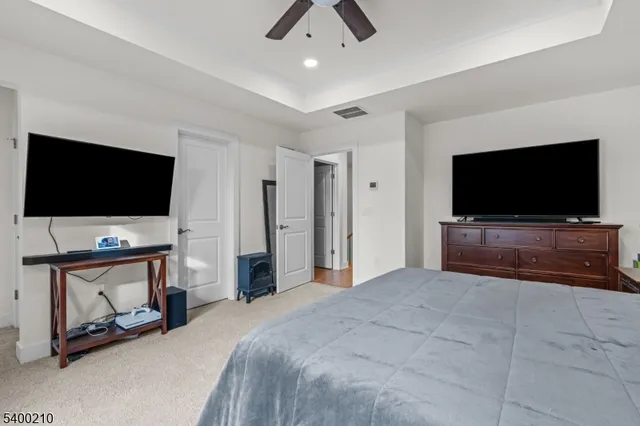 a bedroom with furniture and flat screen tv