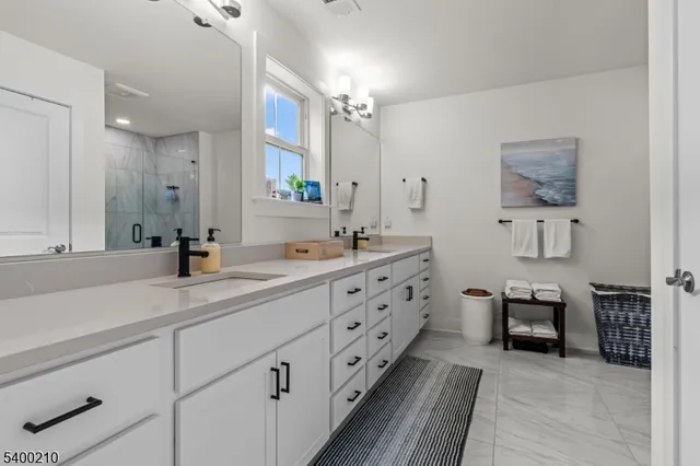 a spacious bathroom with double sink and a mirror