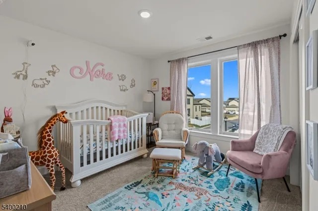 a bedroom with furniture and a large window