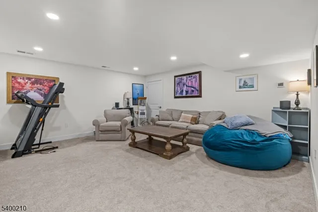 a living room with furniture gym equipment and a window