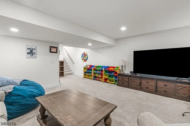 a view of a livingroom with furniture and a flat screen tv