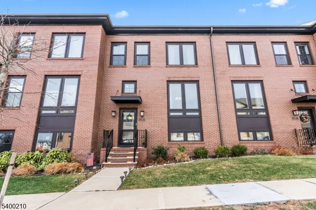 front view of brick house with a yard