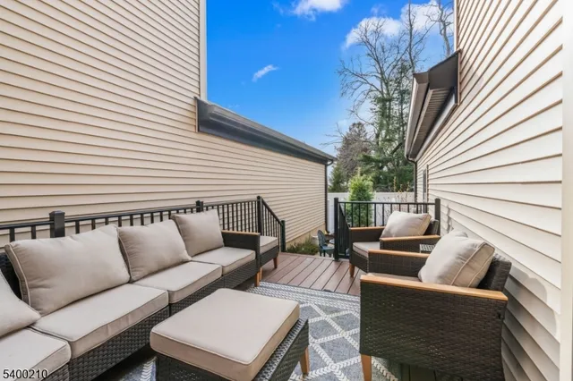 a view of a patio with couches and a potted plant on a table