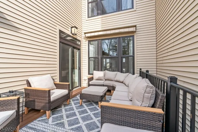 a view of a patio with couches chairs and a wooden floor