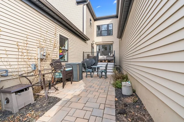 a view of a patio with table and chairs and potted plants