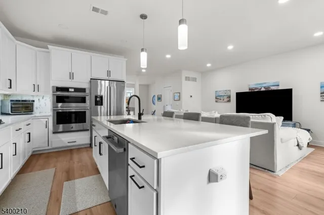 a kitchen with cabinets a sink and appliances