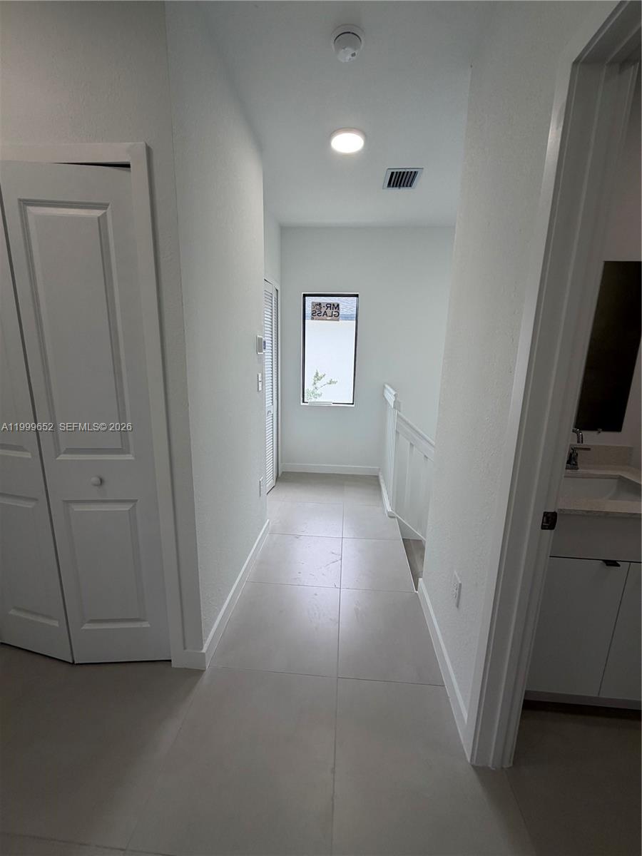 8034 Northwest 14th Place, Unit 8034 Miami, FL 33147 - Photo 11 of 14 a view of hallway with stairs and wooden floor