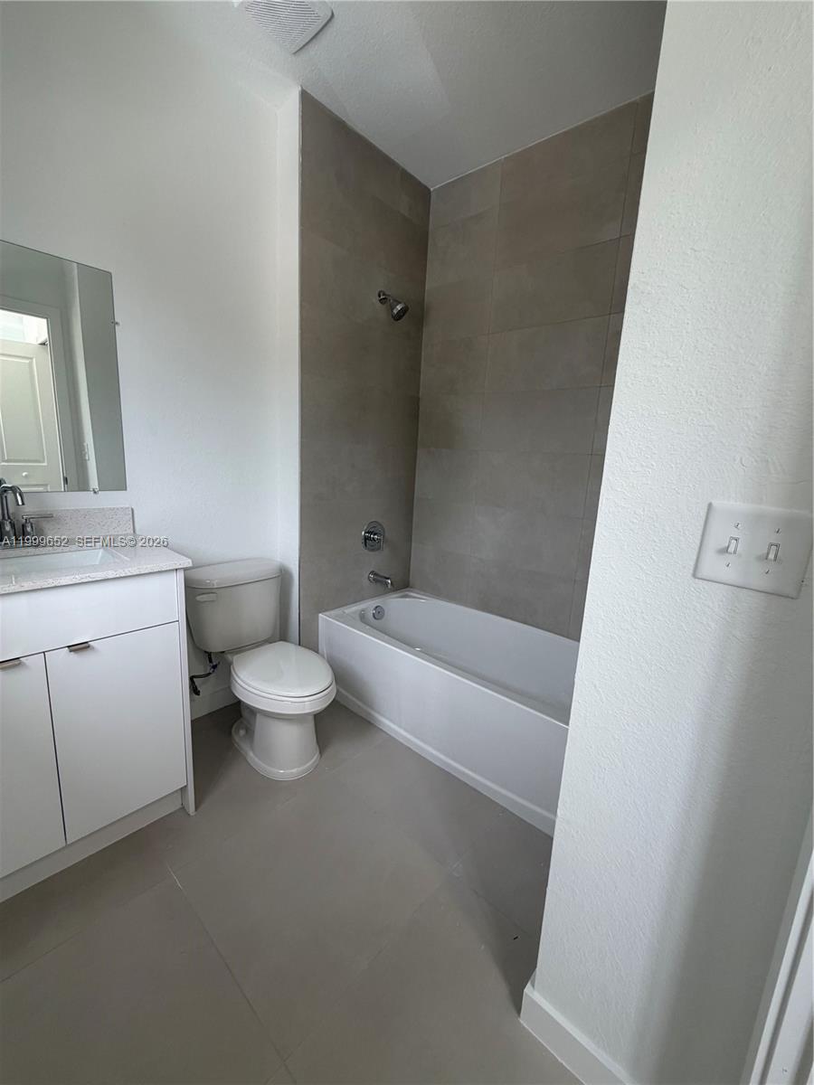 8034 Northwest 14th Place, Unit 8034 Miami, FL 33147 - Photo 4 of 14 a bathroom with a toilet a sink and bathtub