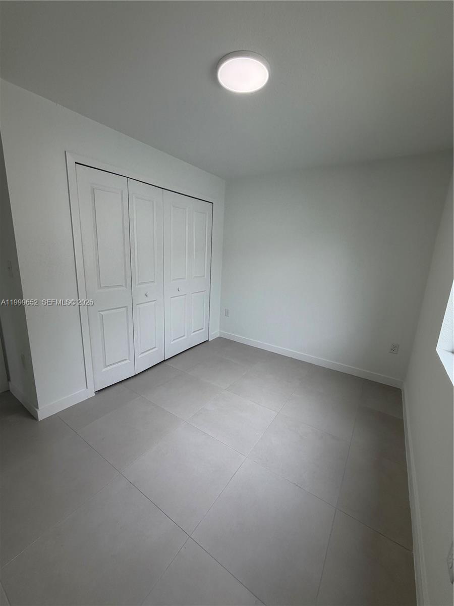 8034 Northwest 14th Place, Unit 8034 Miami, FL 33147 - Photo 6 of 14 a view of an empty room and a window