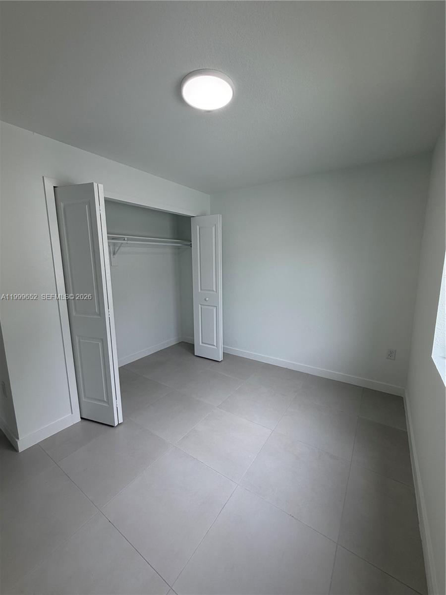 8034 Northwest 14th Place, Unit 8034 Miami, FL 33147 - Photo 7 of 14 an empty room with closet area