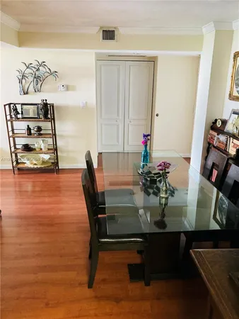 a view of a dining room with furniture and wooden floor