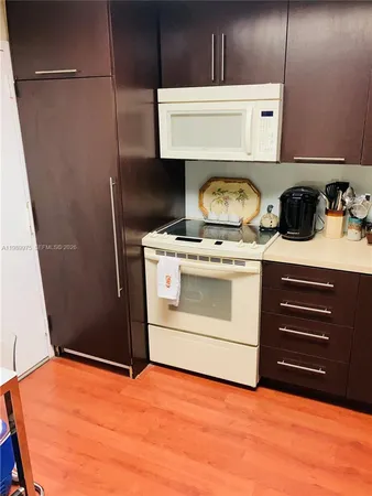 a room with an oven and a washer dryer