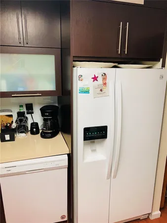 a white refrigerator freezer sitting inside of a kitchen