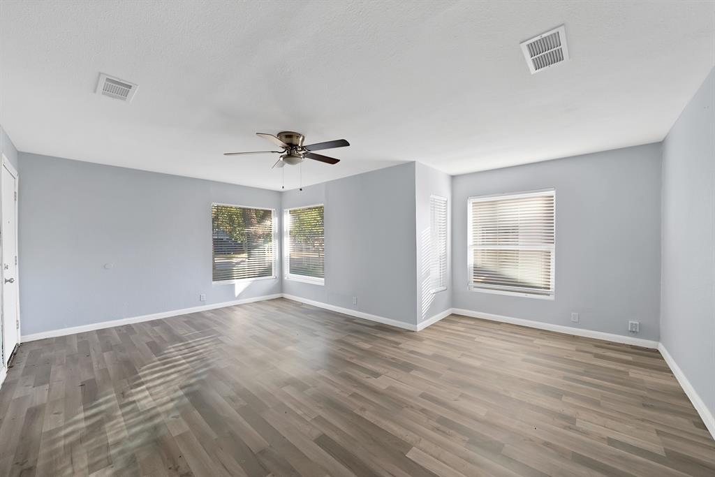 809 Hackamore Street White Settlement, TX 76108 - Photo 3 of 20 a view of an empty room with a window and wooden floor