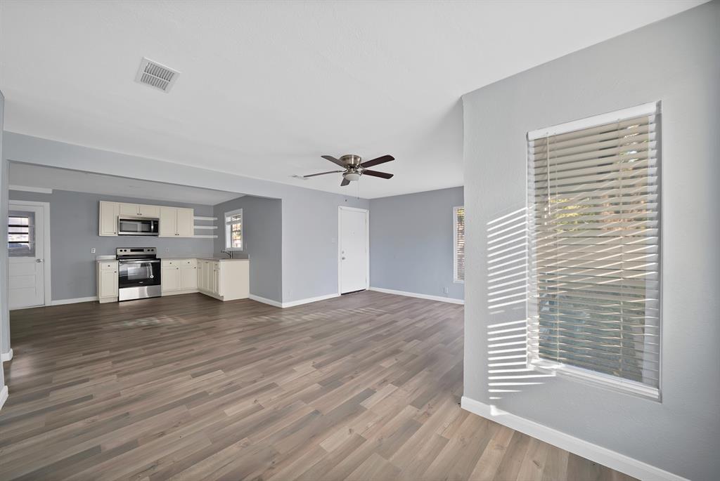 809 Hackamore Street White Settlement, TX 76108 - Photo 5 of 20 a view of empty room with wooden floor and fan