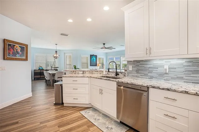a kitchen with a sink cabinets and window