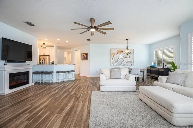 a living room with furniture a fireplace and a flat screen tv