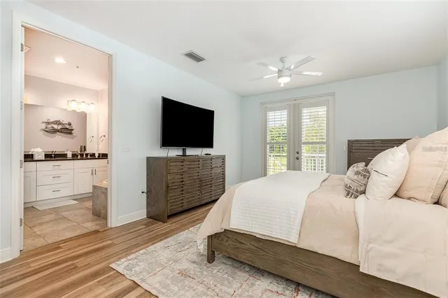 a bedroom with a bed and a flat screen television