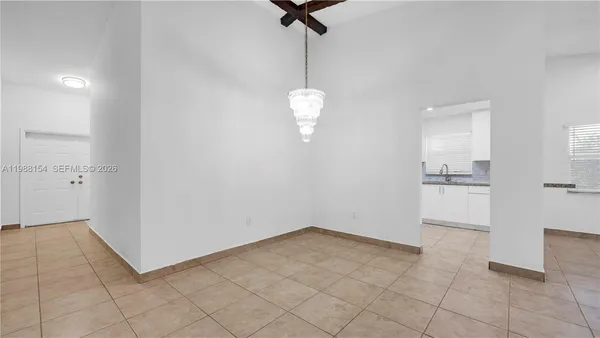 an empty room with chandelier fan