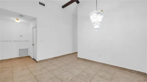 a kitchen with stainless steel appliances granite countertop white cabinets a refrigerator a sink a stove and white cabinets