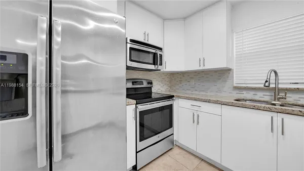 a kitchen with granite countertop a sink and a window