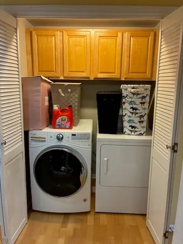 a balcony with wooden floor and trees in a park