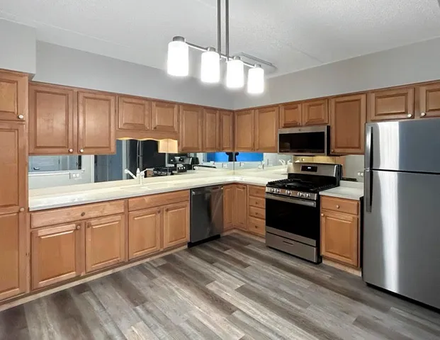 a kitchen with a sink stainless steel appliances and cabinets