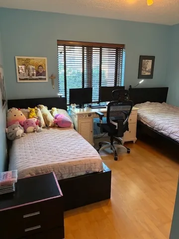 a bedroom with bed couch and window