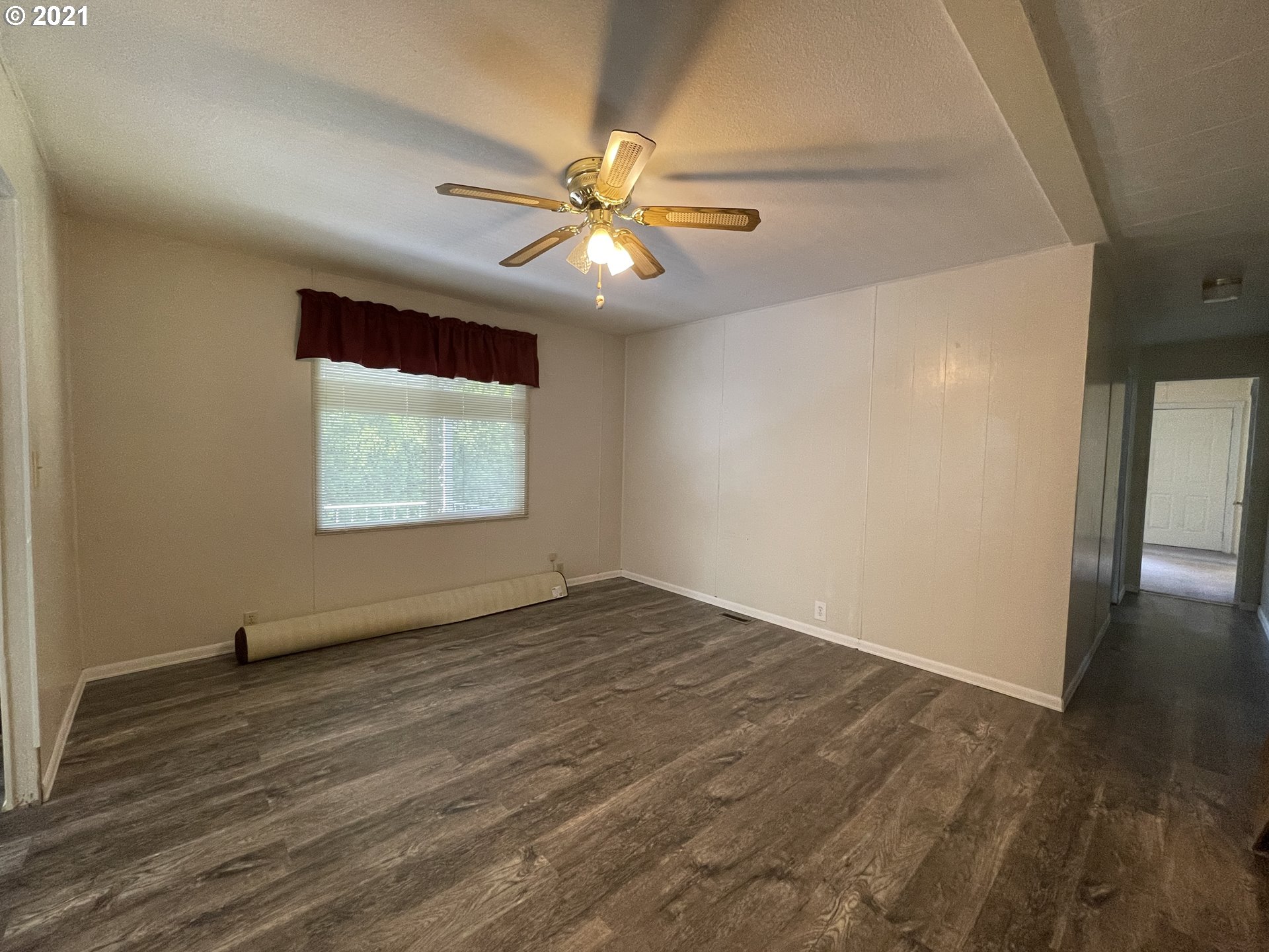 1125 58th Street, Unit SP001 Springfield, OR 97478 - Photo 10 of 28 an empty room with wooden floor fan and windows