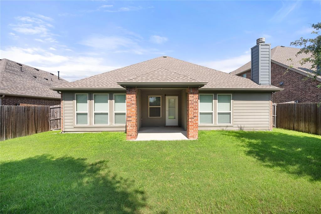520 Rustic Oak Lane McKinney, TX 75072 - Photo 26 of 30 Expansive grassy yard with a covered concrete patio, horizontal siding exterior, and a shingled roof